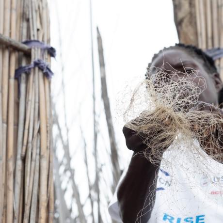 An anonymous woman holds a fishing net in one of Zambia's remote fishing camps.
